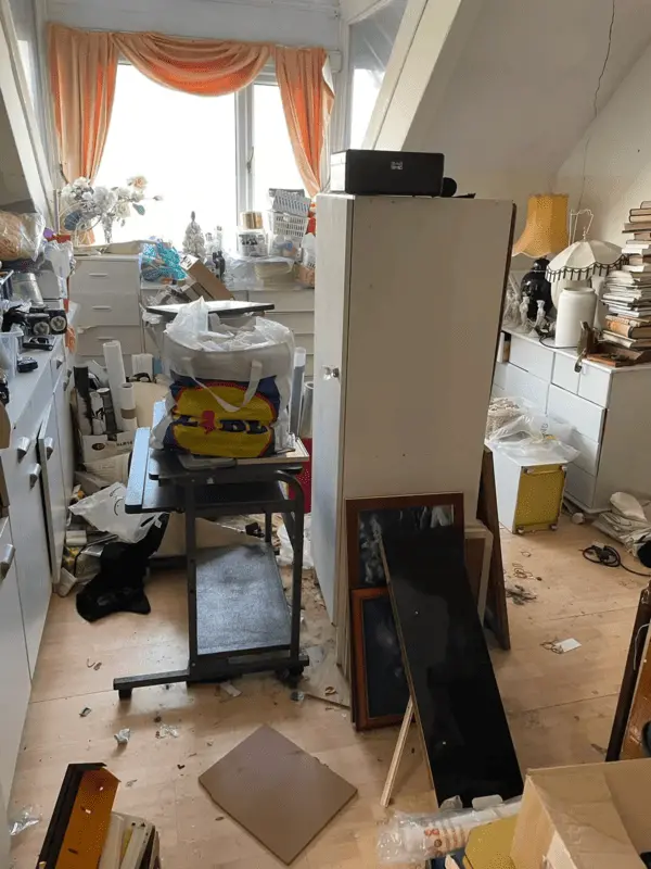 Before rubbish removal in Penzance — cluttered property full of items